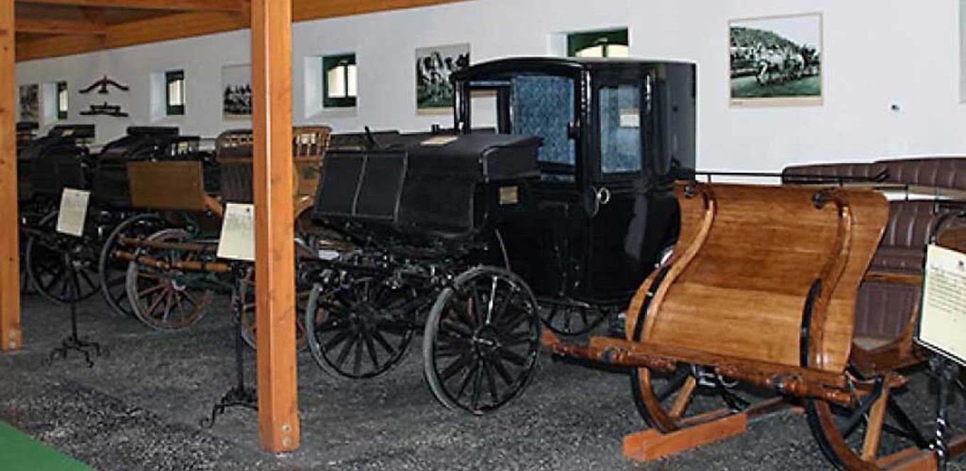 Horse-drawn carriage exhibition with antique vehicles